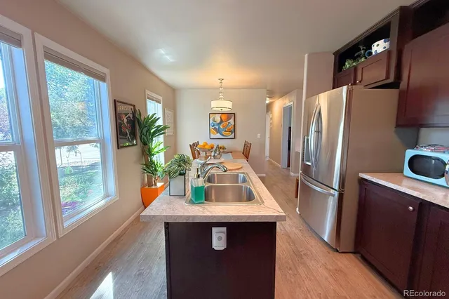 a kitchen with stainless steel appliances a sink stove and refrigerator