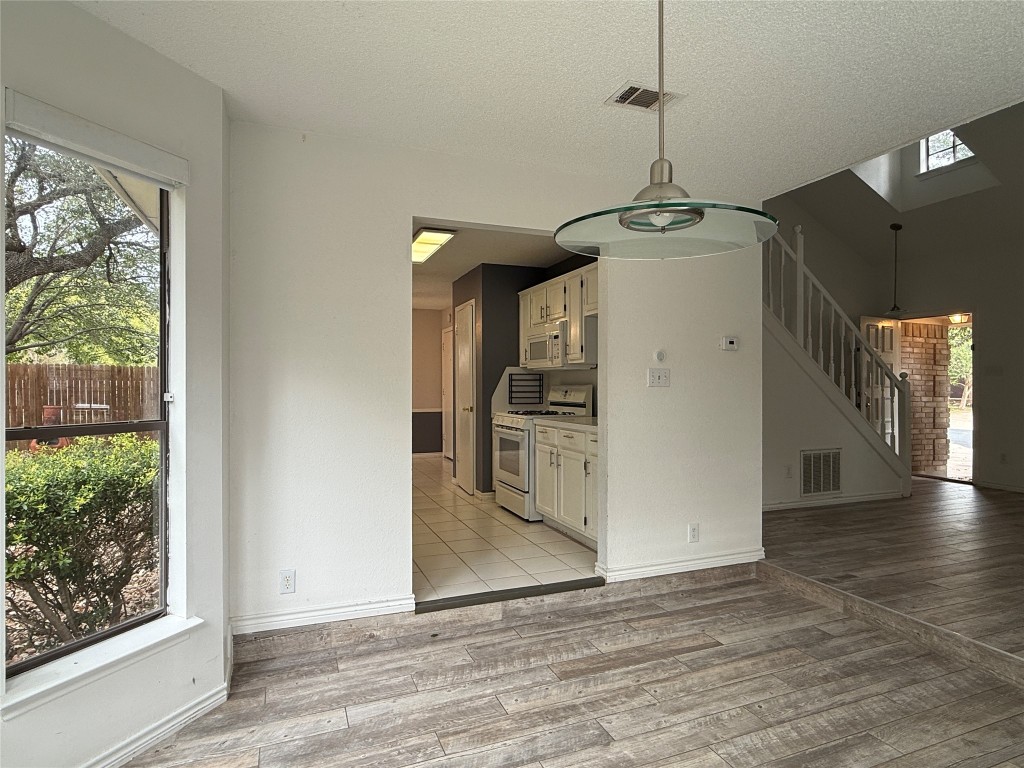 2503 Autrey Drive Leander, TX 78641 - Photo 11 of 39 a view of a kitchen with wooden floor and a window