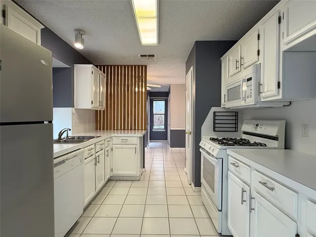 a kitchen with stainless steel appliances a stove sink and cabinets