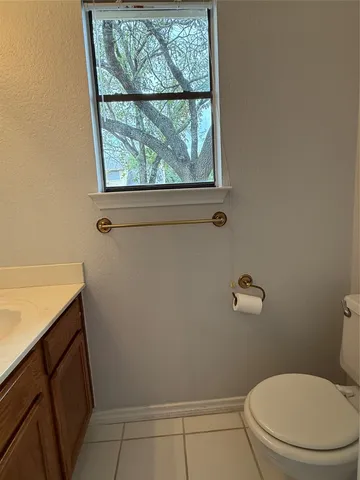 a white toilet sitting next to a window