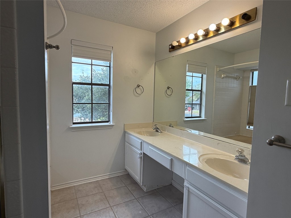 2503 Autrey Drive Leander, TX 78641 - Photo 27 of 39 a bathroom with a sink double vanity and a mirror