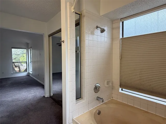 a bathroom with a tub and a shower