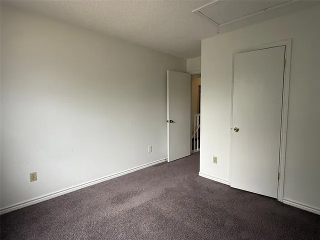 an empty room with closet area