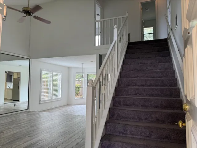 a view of staircase with white walls and a window