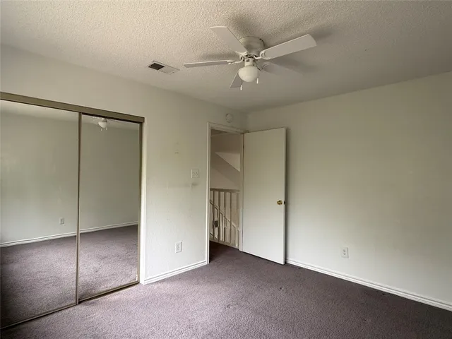 an empty room with fan and a ceiling fan