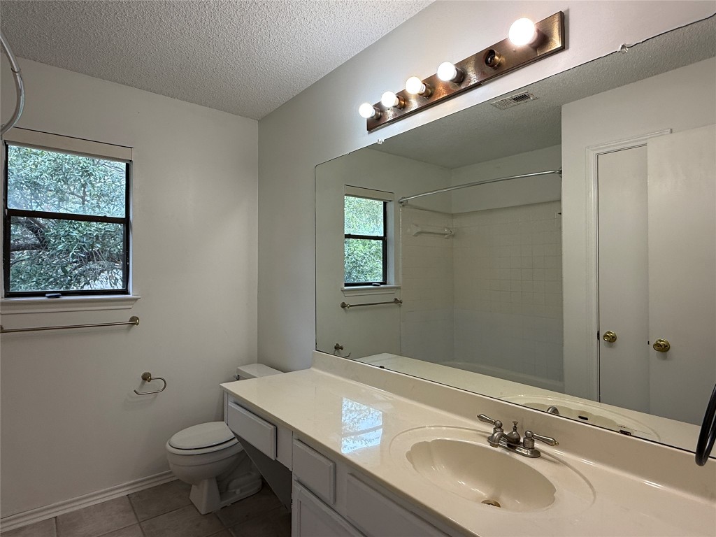 2503 Autrey Drive Leander, TX 78641 - Photo 33 of 39 a bathroom with a sink and mirror with toilet