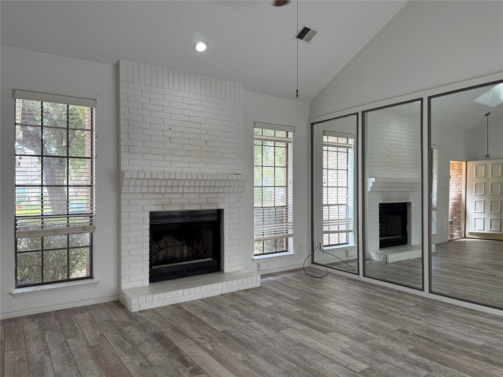 2503 Autrey Drive Leander, TX 78641 - Photo 5 of 39 a view of an empty room with wooden floor fireplace and a window
