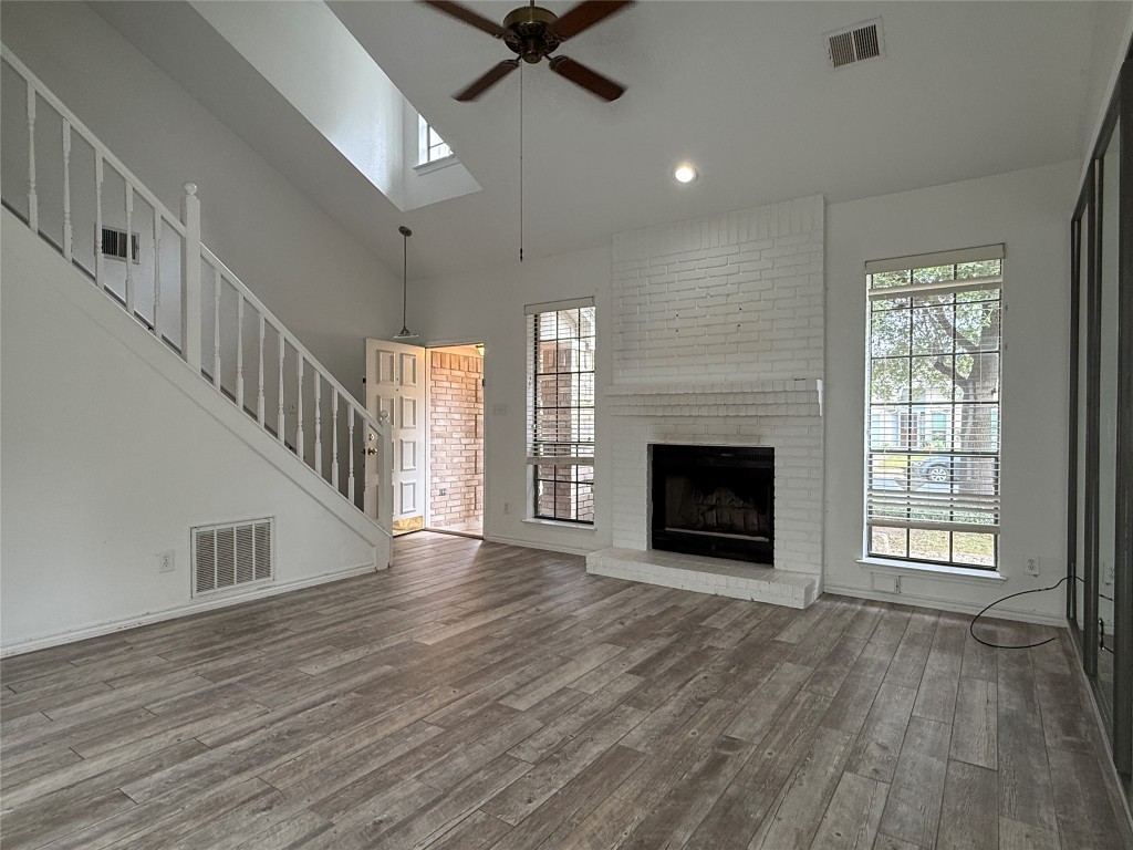 2503 Autrey Drive Leander, TX 78641 - Photo 8 of 39 a view of an empty room with wooden floor fireplace and a window