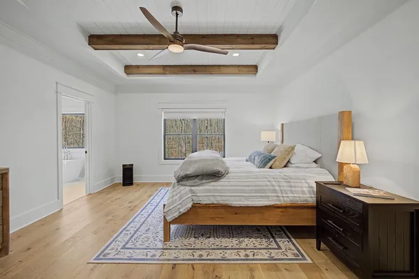 a spacious bathroom with a tub sink and mirror