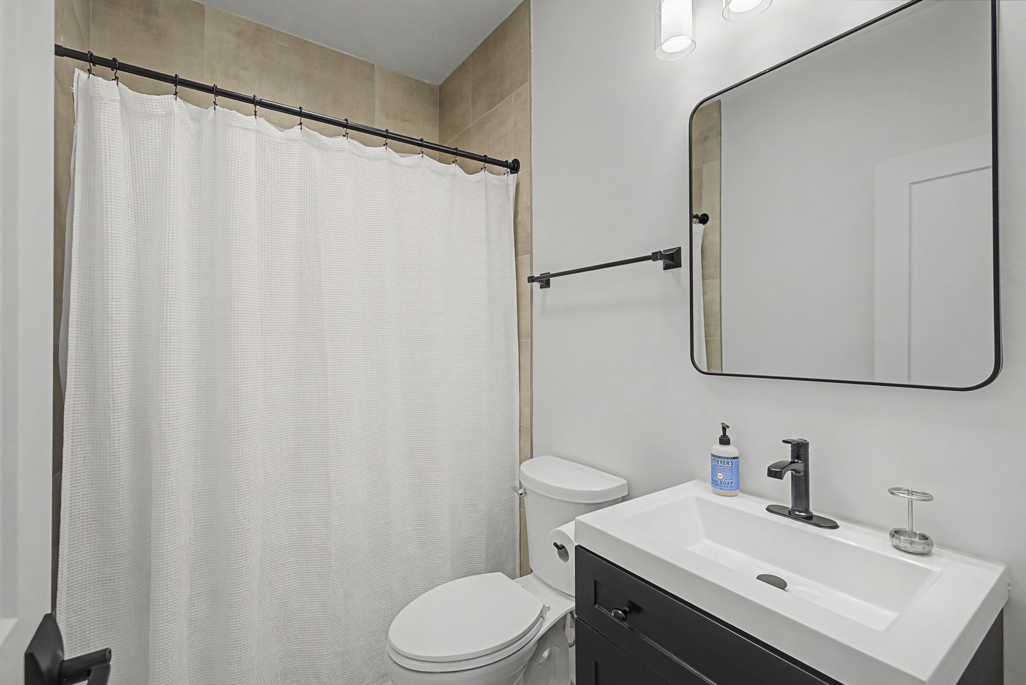 1863 Lake Louisa Loop Monteagle, TN 37356 - Photo 7 of 63 a bathroom with a sink a toilet and shower curtain