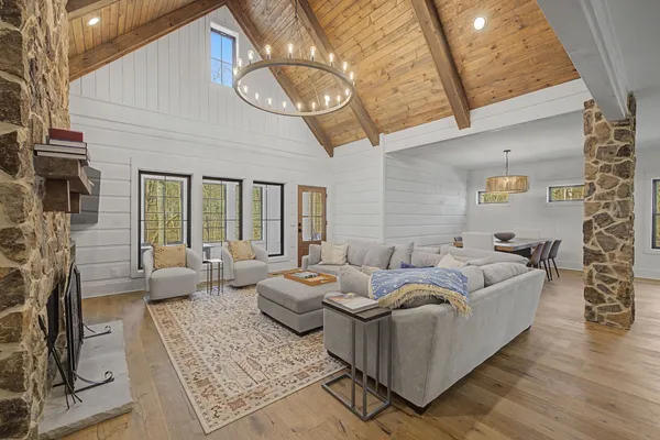 a living room with furniture a flat screen tv and a fireplace