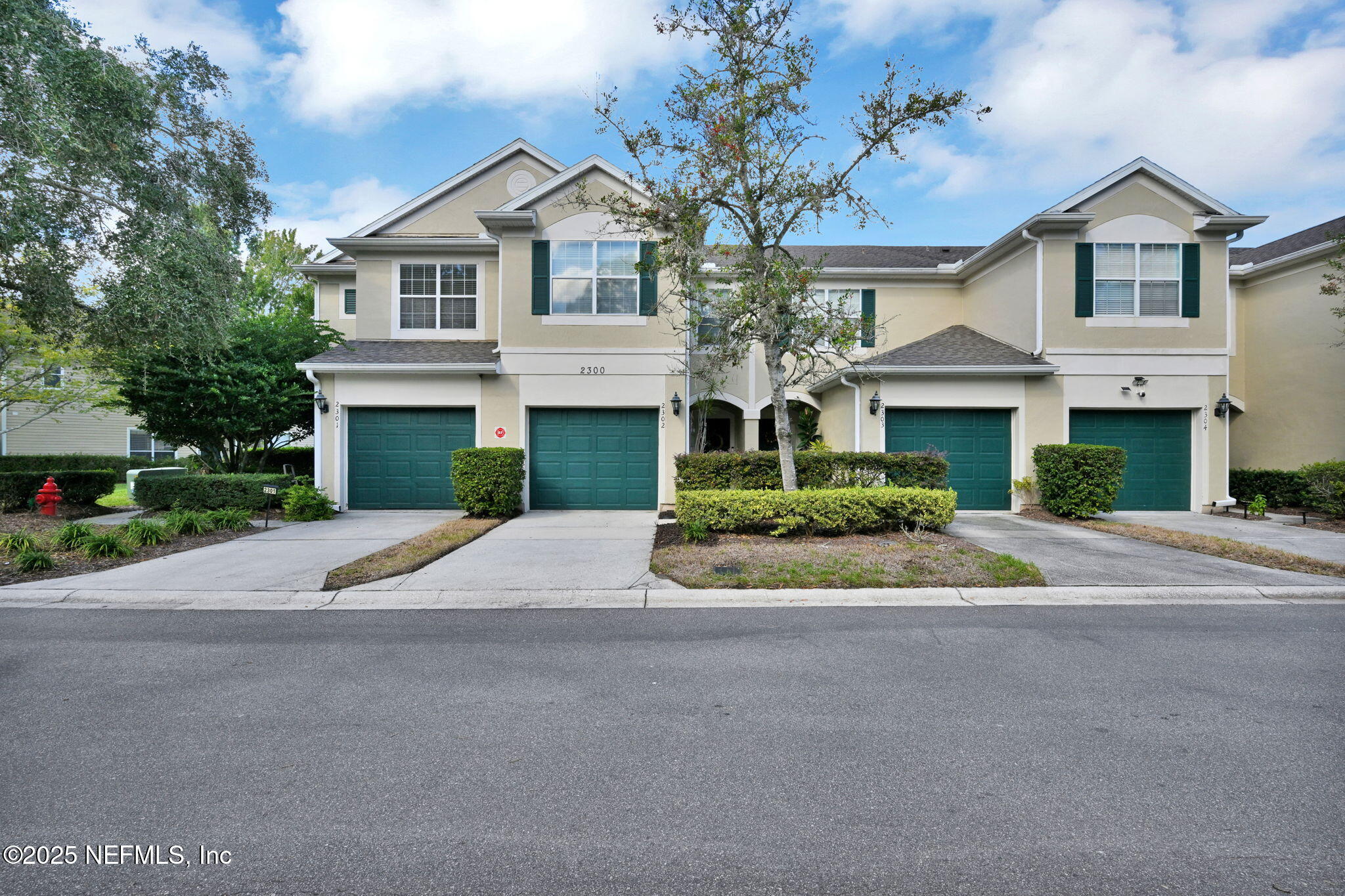 7990 Baymeadows Road East, Unit 2302 Jacksonville, FL 32256 - Photo 1 of 66 a front view of a house with a yard and garage