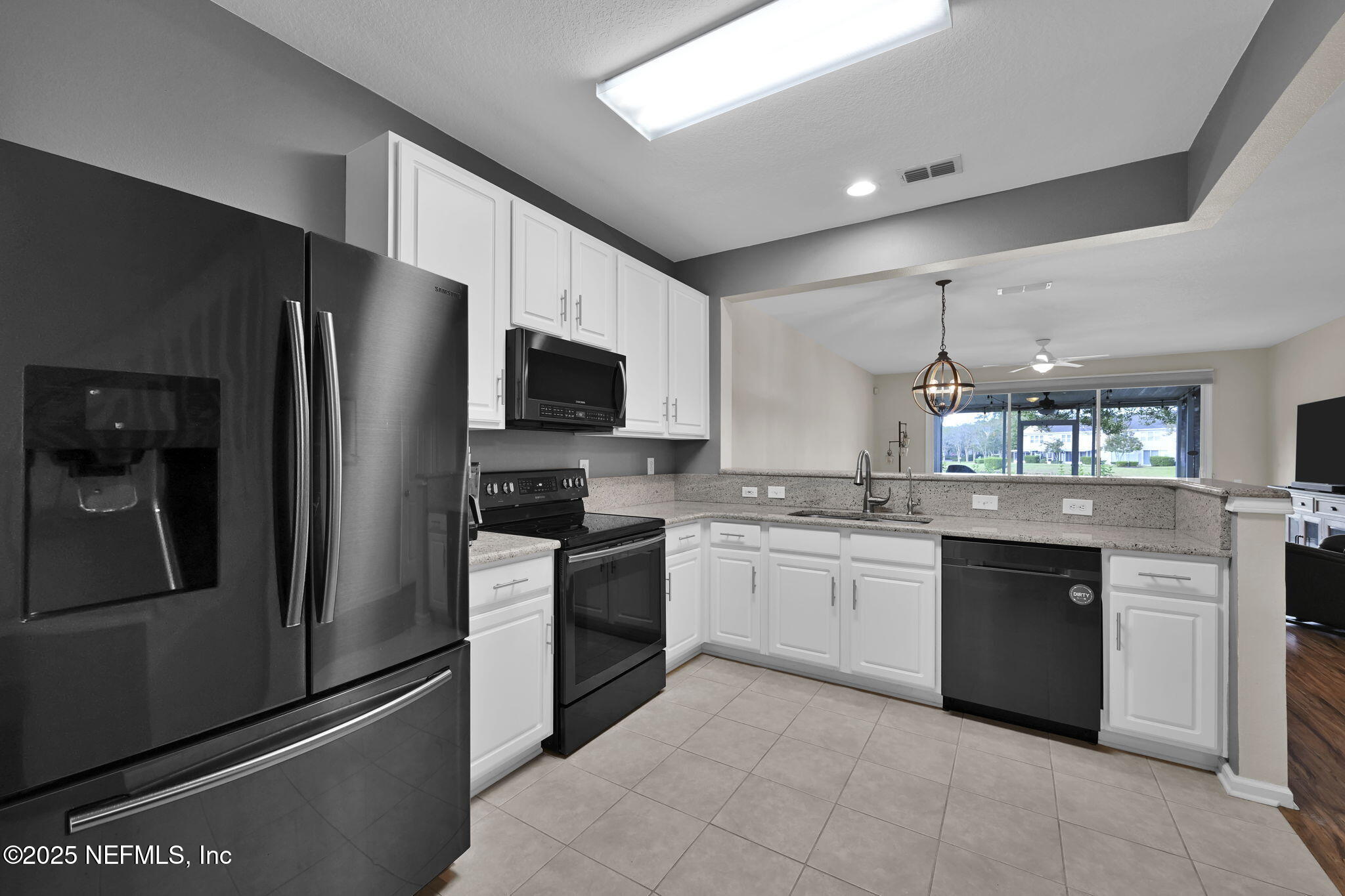 7990 Baymeadows Road East, Unit 2302 Jacksonville, FL 32256 - Photo 11 of 66 a kitchen with a sink stainless steel appliances and cabinets