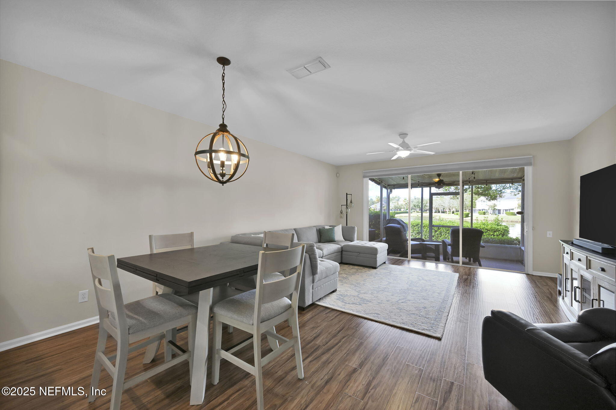 7990 Baymeadows Road East, Unit 2302 Jacksonville, FL 32256 - Photo 16 of 66 a view of a dining room with furniture wooden floor and a chandelier