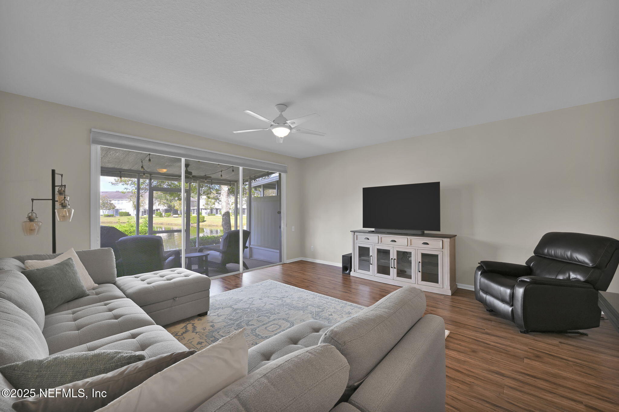 7990 Baymeadows Road East, Unit 2302 Jacksonville, FL 32256 - Photo 18 of 66 a living room with furniture and a flat screen tv