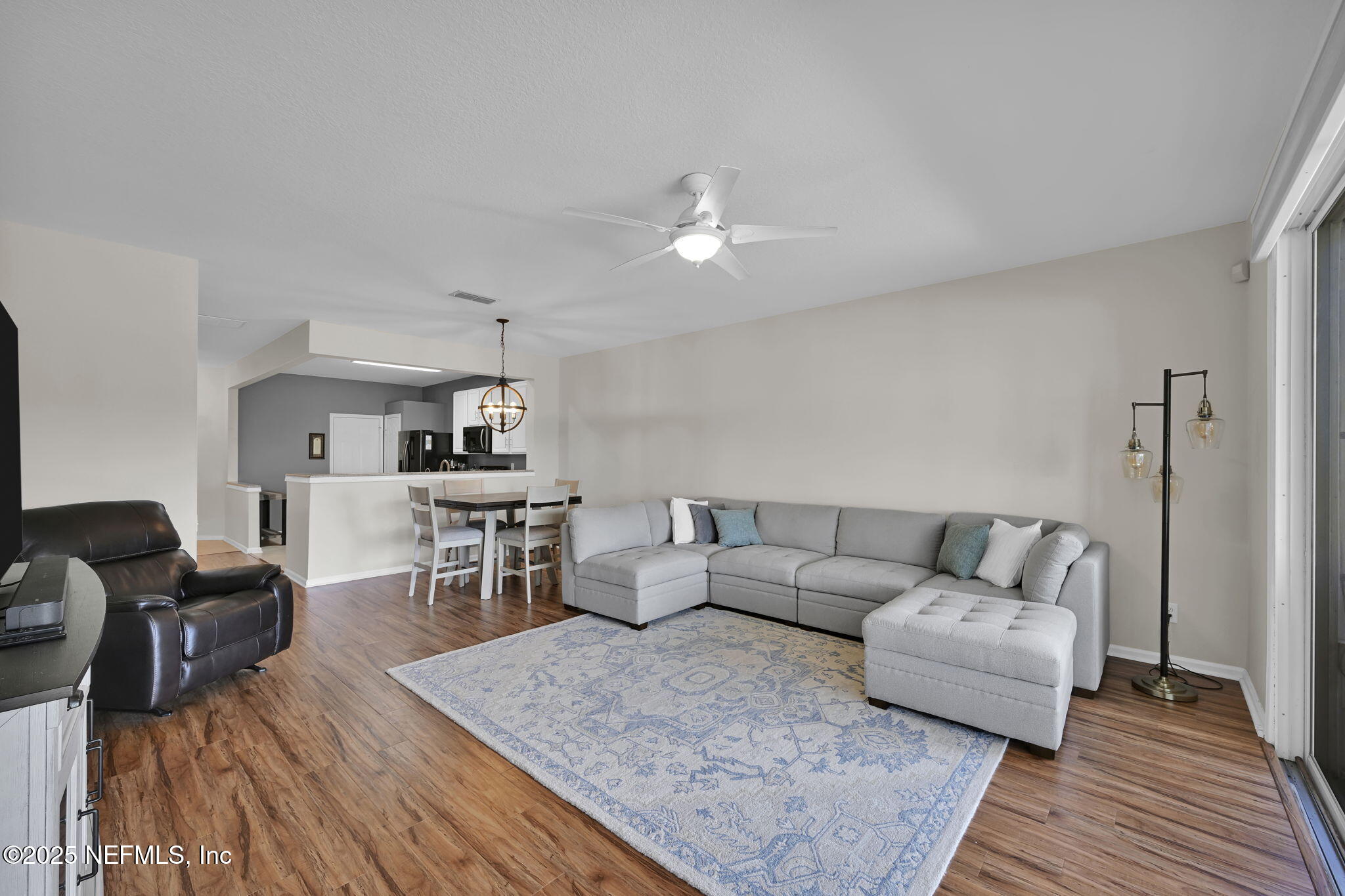 7990 Baymeadows Road East, Unit 2302 Jacksonville, FL 32256 - Photo 20 of 66 a living room with furniture and wooden floor