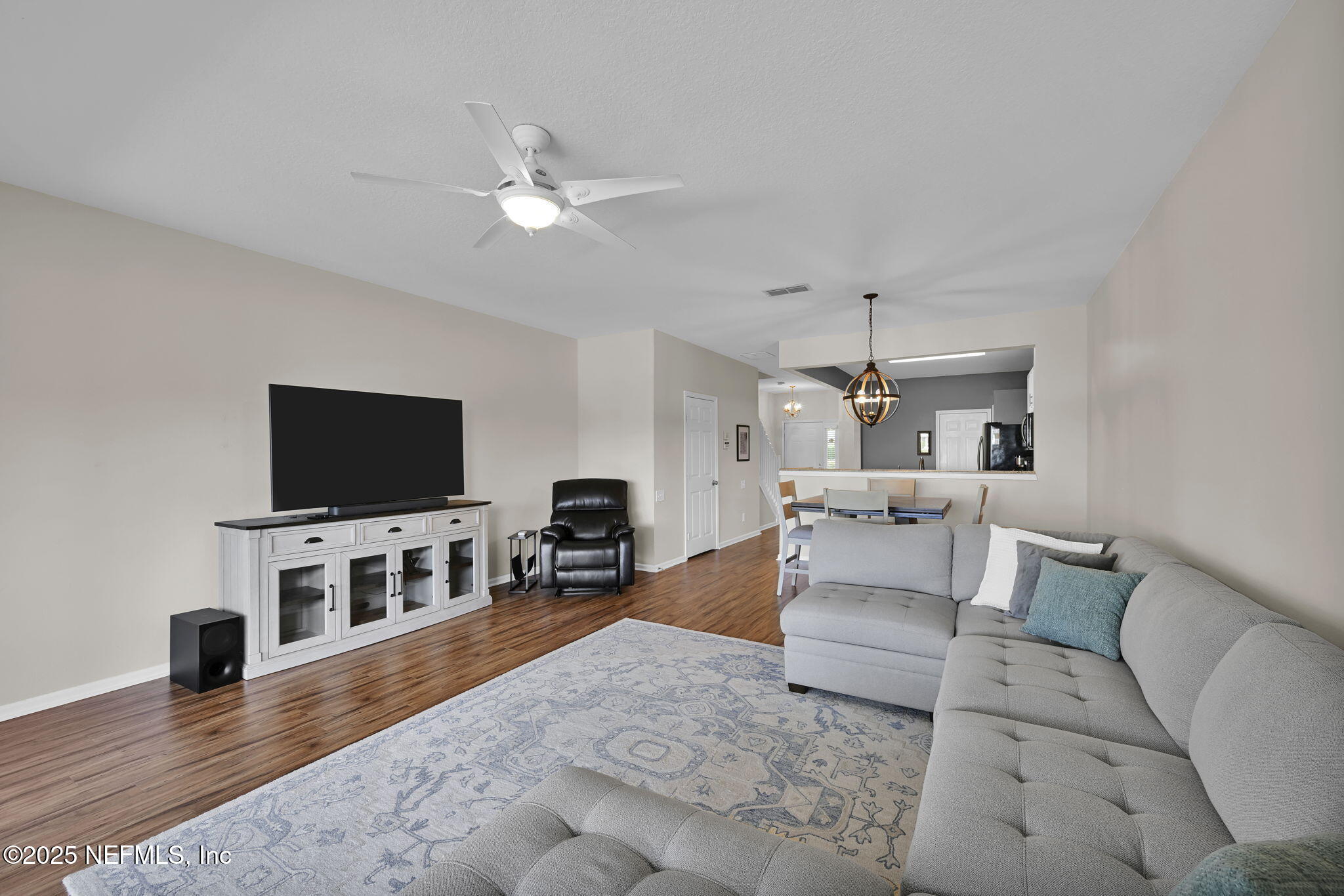 7990 Baymeadows Road East, Unit 2302 Jacksonville, FL 32256 - Photo 21 of 66 a living room with furniture and a flat screen tv