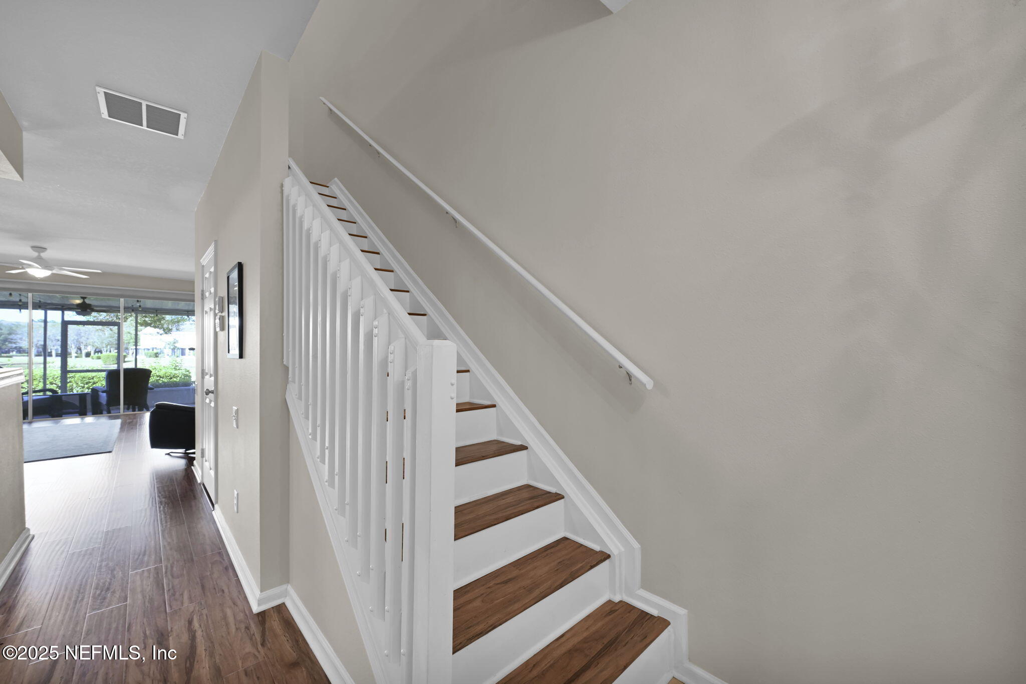 7990 Baymeadows Road East, Unit 2302 Jacksonville, FL 32256 - Photo 22 of 66 a view of a hallway with wooden floor and staircase