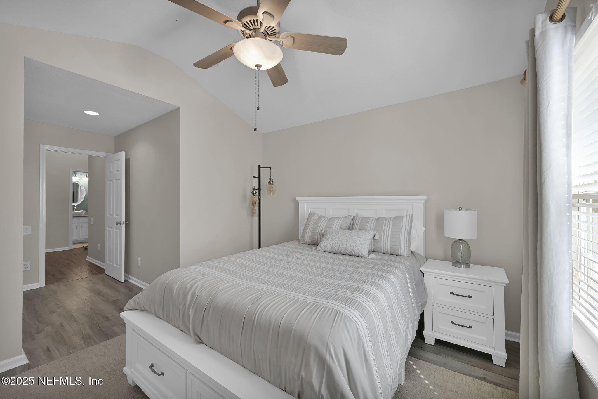 7990 Baymeadows Road East, Unit 2302 Jacksonville, FL 32256 - Photo 24 of 66 a bedroom with a large bed and a chandelier