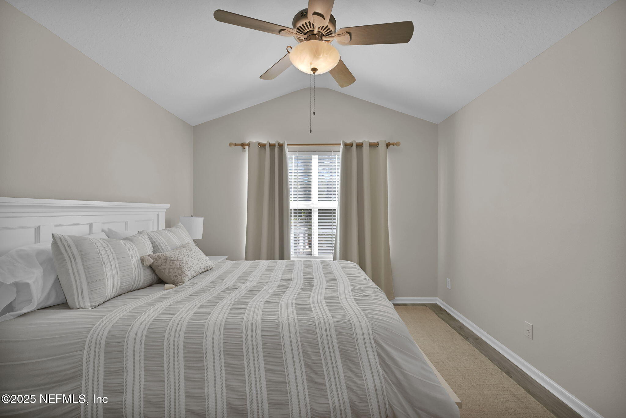 7990 Baymeadows Road East, Unit 2302 Jacksonville, FL 32256 - Photo 25 of 66 a bedroom with a large bed and a chandelier