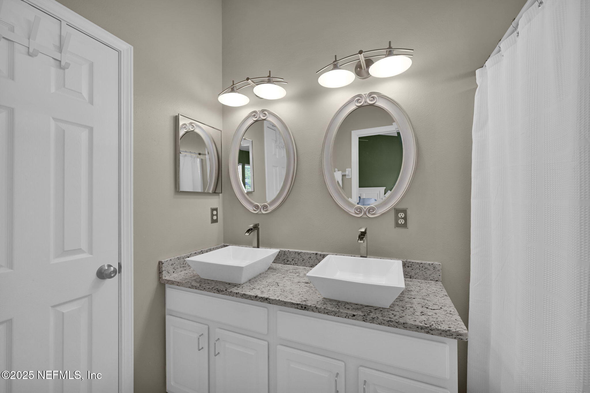 7990 Baymeadows Road East, Unit 2302 Jacksonville, FL 32256 - Photo 33 of 66 a bathroom with a granite countertop double vanity sink and a mirror