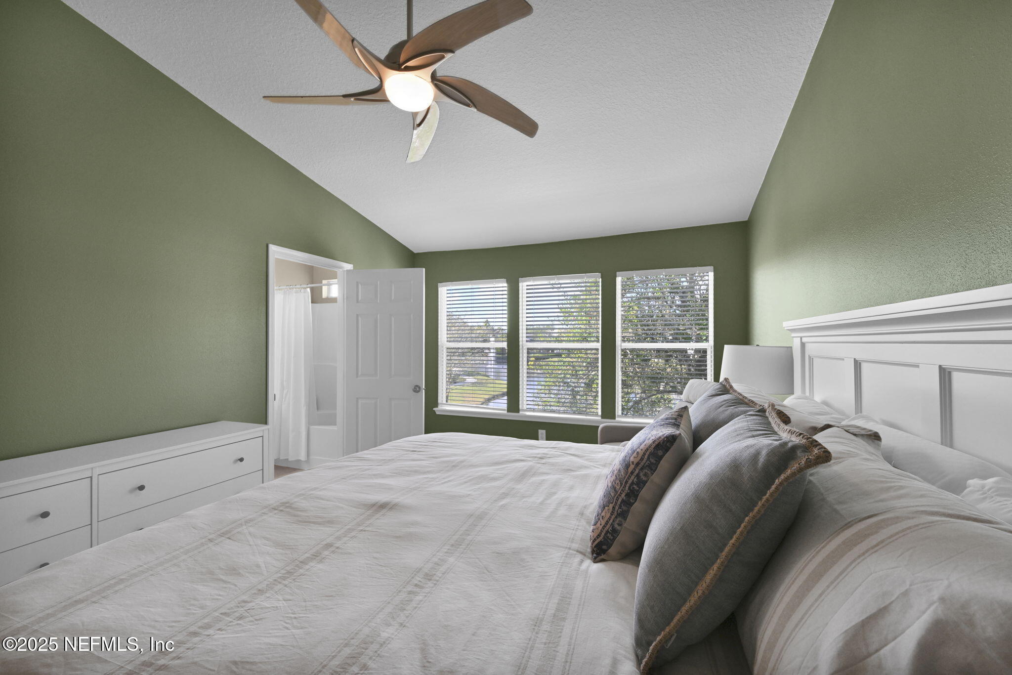 7990 Baymeadows Road East, Unit 2302 Jacksonville, FL 32256 - Photo 35 of 66 a bed sitting in a bedroom next to a window