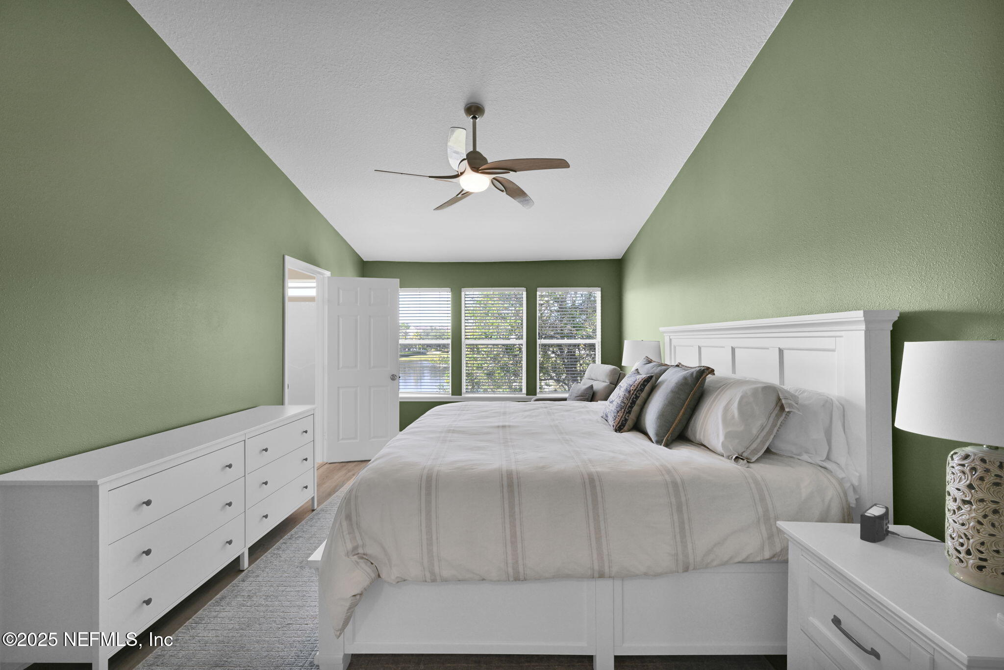 7990 Baymeadows Road East, Unit 2302 Jacksonville, FL 32256 - Photo 37 of 66 a bedroom with a large bed and a chandelier