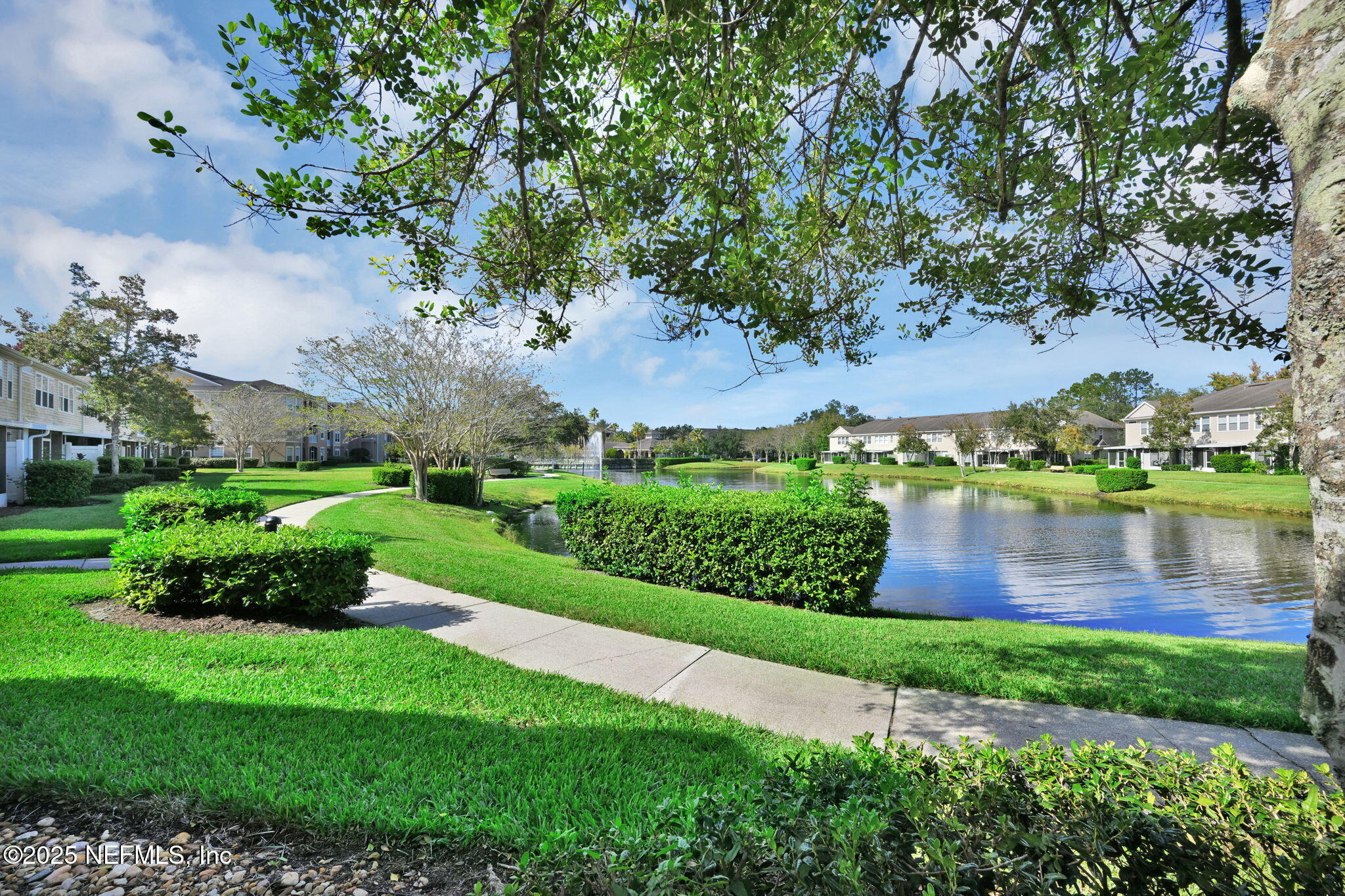 7990 Baymeadows Road East, Unit 2302 Jacksonville, FL 32256 - Photo 41 of 66 a view of a garden with a lake