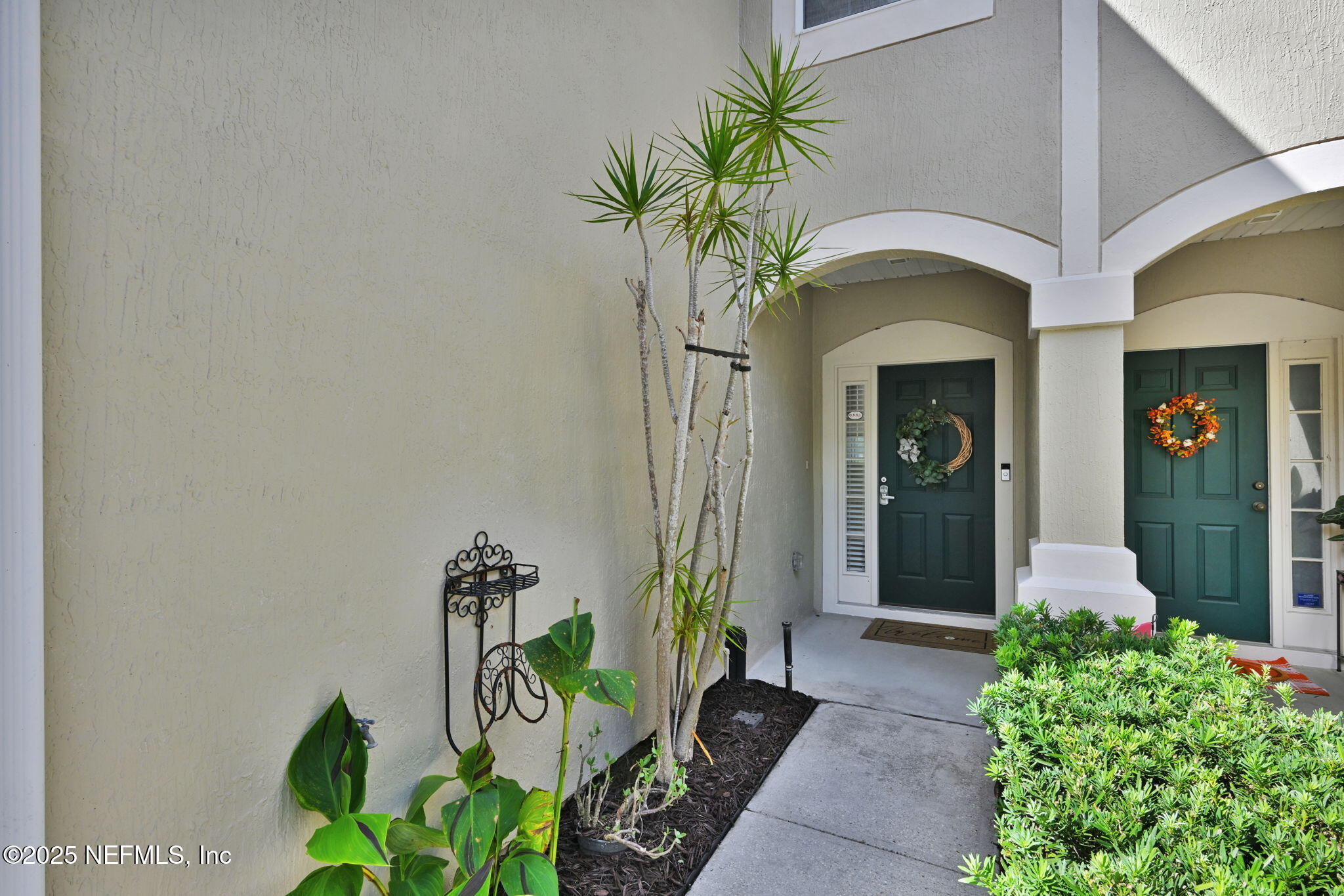 7990 Baymeadows Road East, Unit 2302 Jacksonville, FL 32256 - Photo 5 of 66 a front view of a house with a blue plant