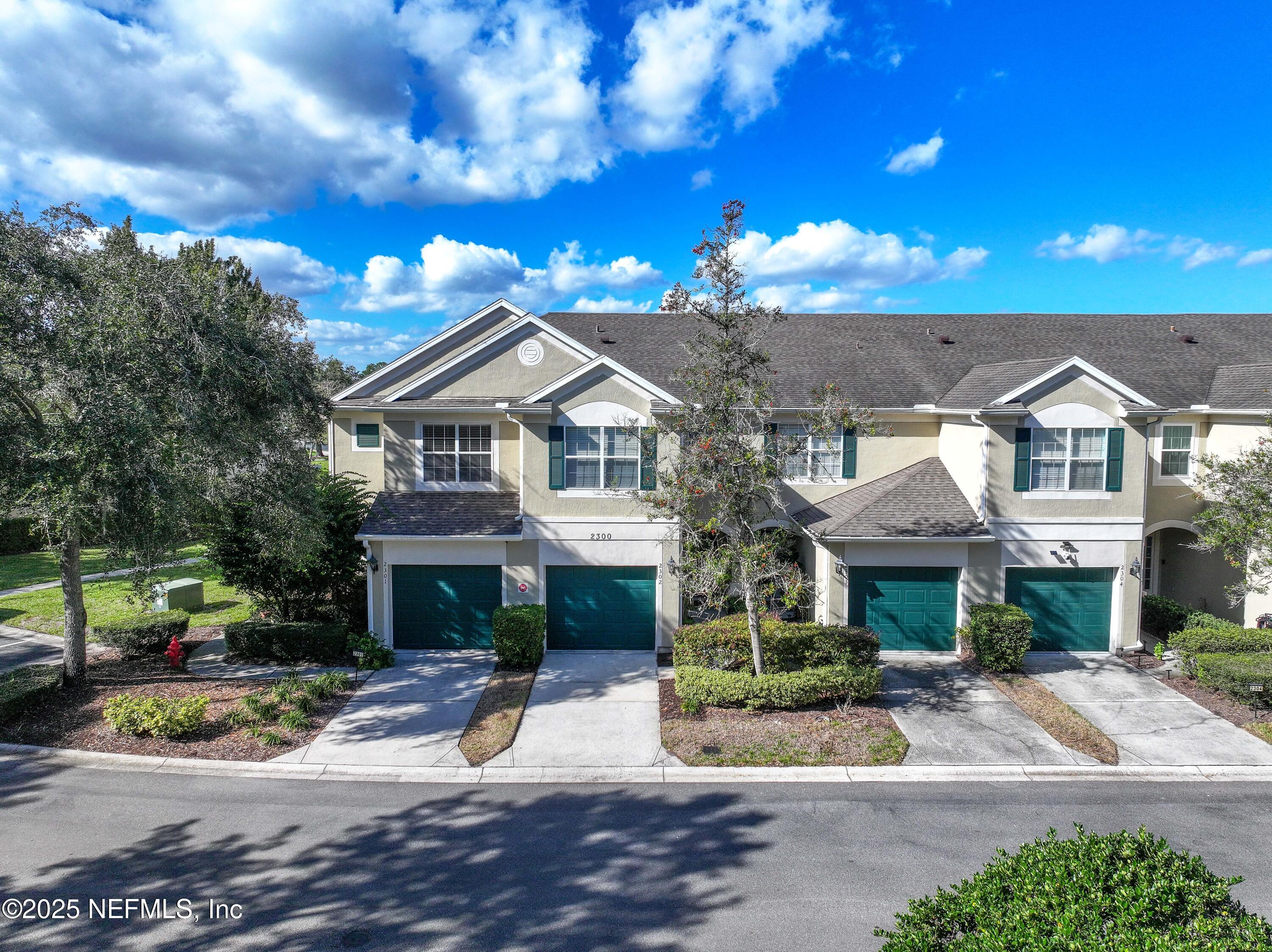 7990 Baymeadows Road East, Unit 2302 Jacksonville, FL 32256 - Photo 53 of 66 a view of a house with a yard and potted plants