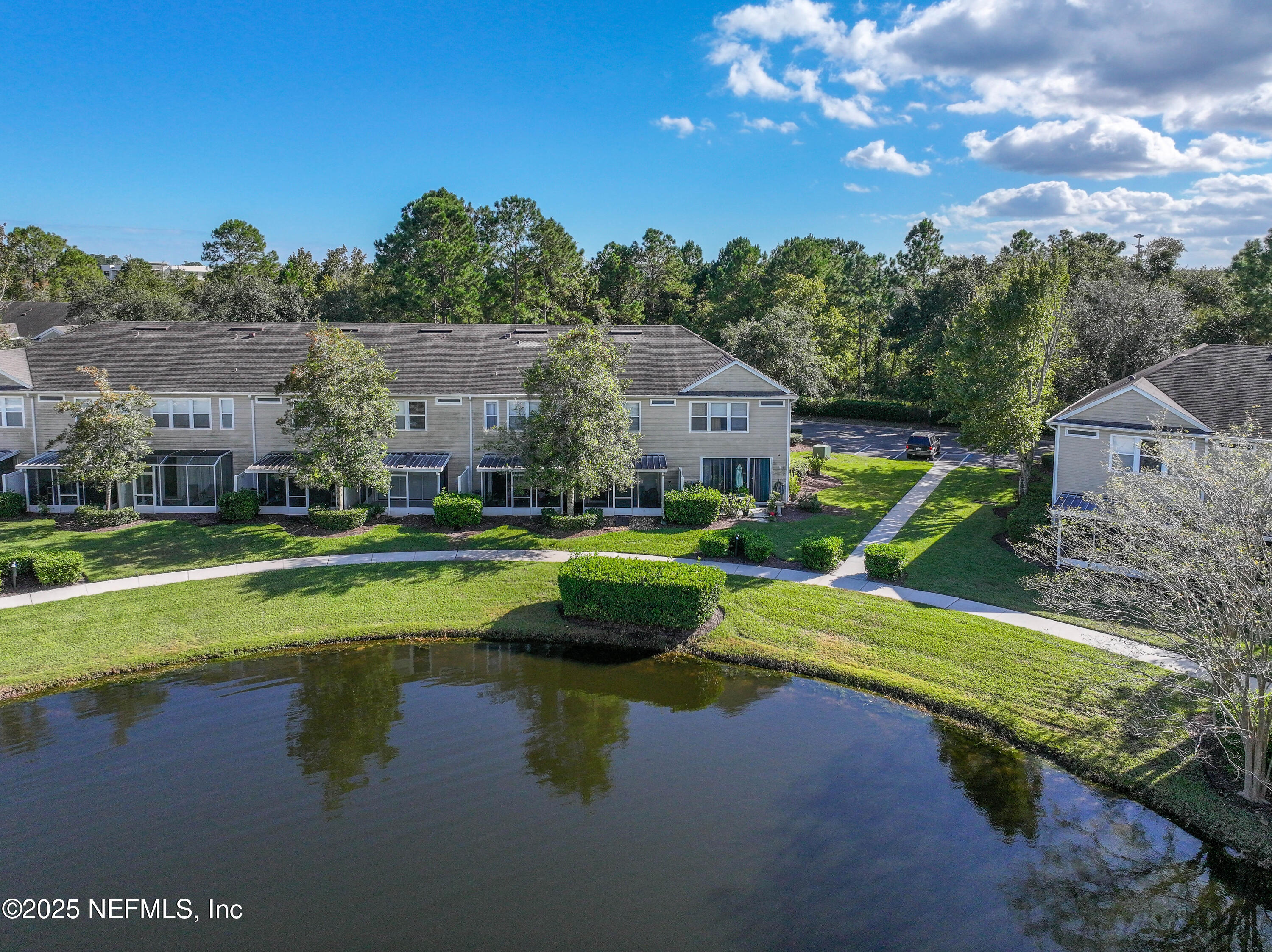 7990 Baymeadows Road East, Unit 2302 Jacksonville, FL 32256 - Photo 54 of 66 a view of a house with swimming pool and a yard