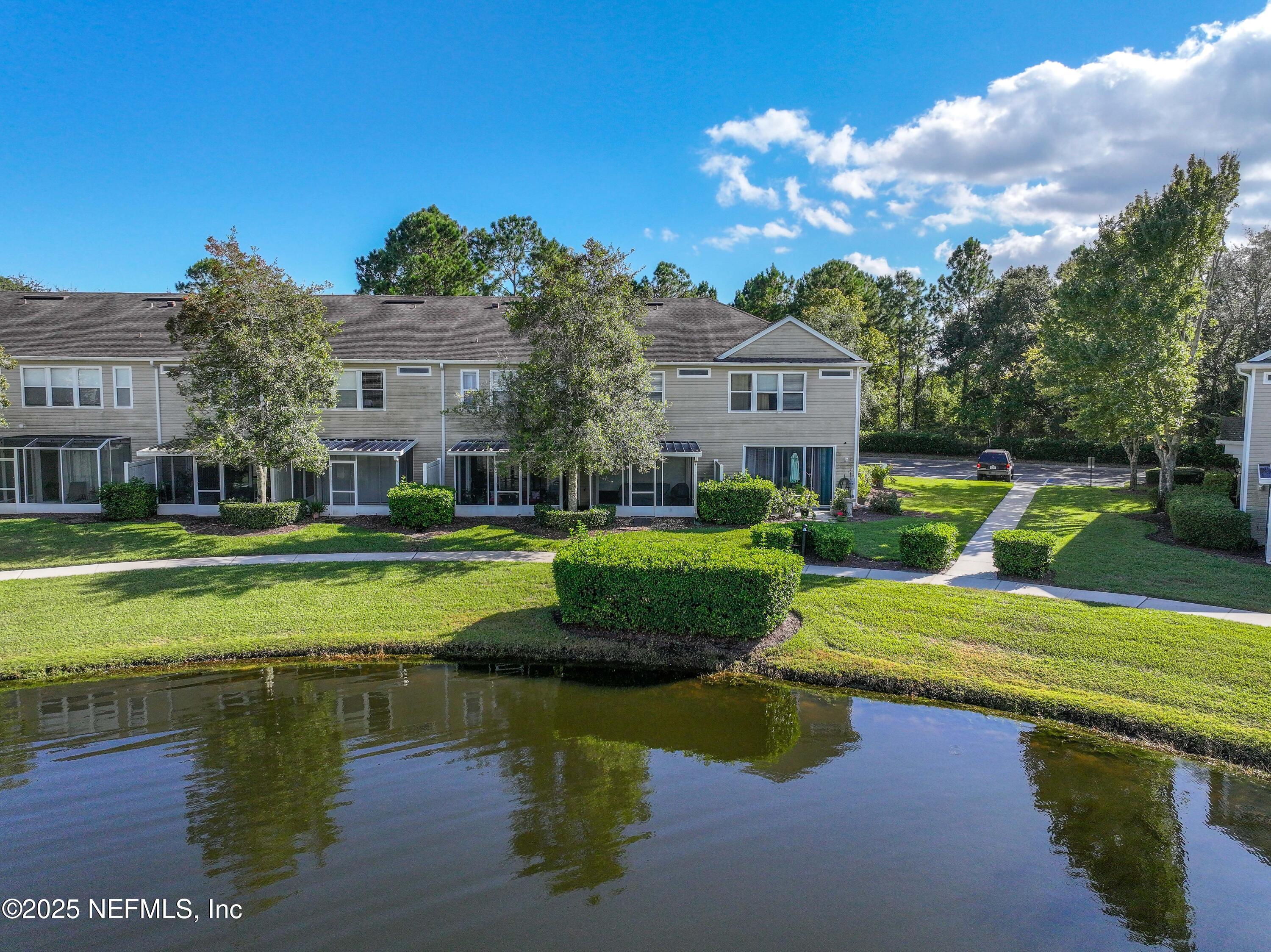 7990 Baymeadows Road East, Unit 2302 Jacksonville, FL 32256 - Photo 56 of 66 a view of a house with a yard
