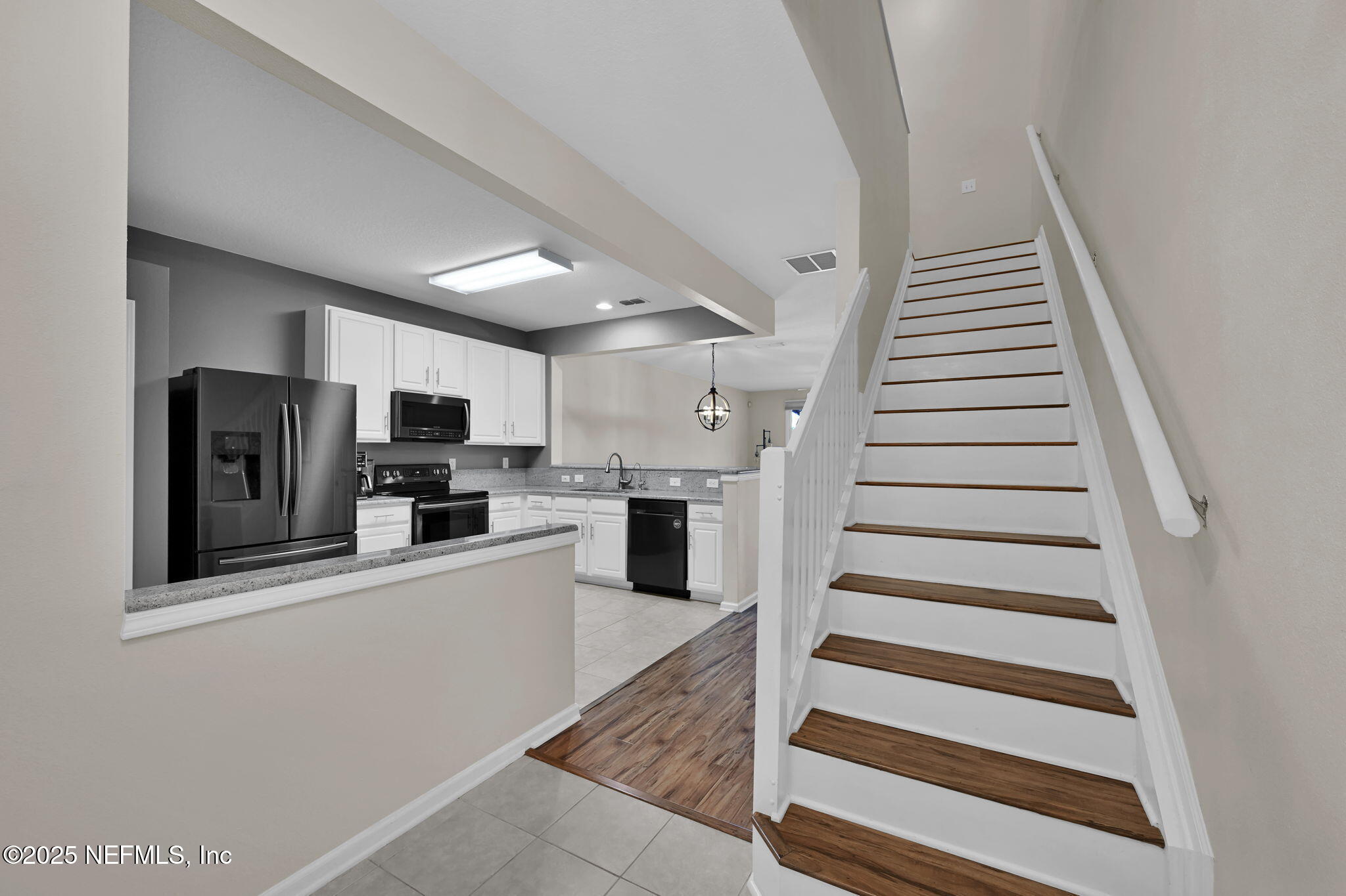 7990 Baymeadows Road East, Unit 2302 Jacksonville, FL 32256 - Photo 7 of 66 a kitchen with stainless steel appliances kitchen island sink refrigerator and stove