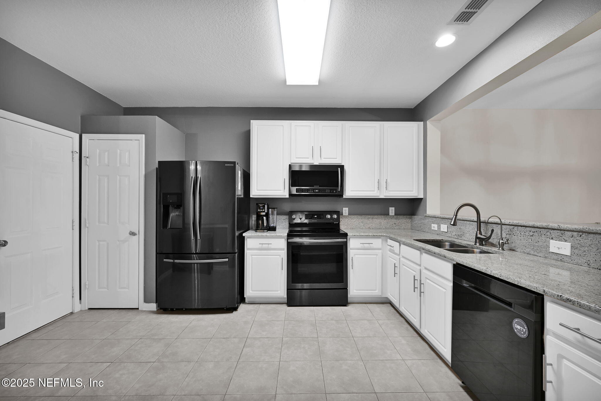 7990 Baymeadows Road East, Unit 2302 Jacksonville, FL 32256 - Photo 8 of 66 a kitchen with stainless steel appliances granite countertop a refrigerator sink and stove