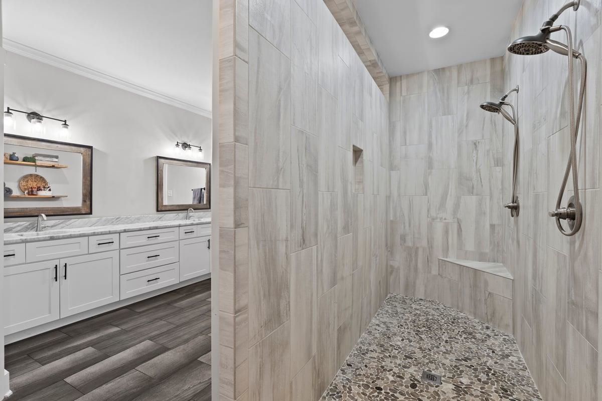 678 Morris Road Covington, TN 38019 - Photo 15 of 40 Full bath with double vanity, a tile shower, dark wood-style flooring, and crown molding