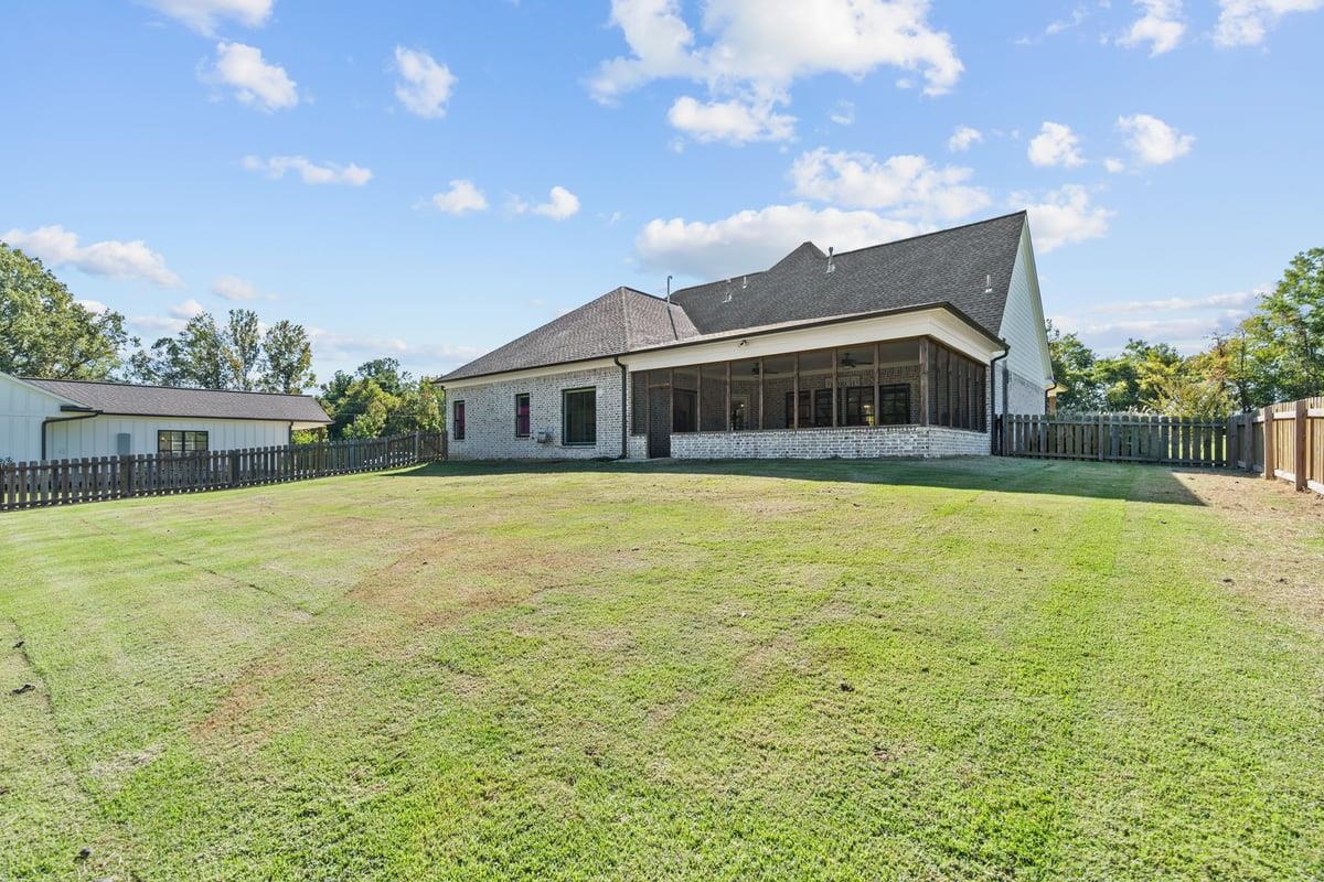 678 Morris Road Covington, TN 38019 - Photo 29 of 40 Back of property with a fenced backyard, brick siding, a patio area, screen porch and a shingled roof