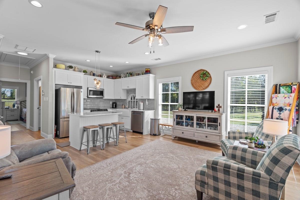678 Morris Road Covington, TN 38019 - Photo 32 of 40 Living room with ornamental molding,, a ceiling fan, recessed lighting, and light wood finished floors