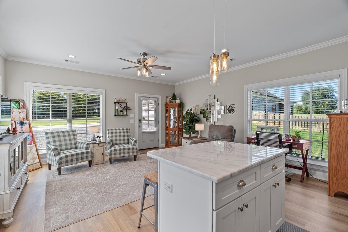 678 Morris Road Covington, TN 38019 - Photo 34 of 40 Kitchen with pendant lighting, crown molding, a center island, white cabinets, and light wood-style flooring