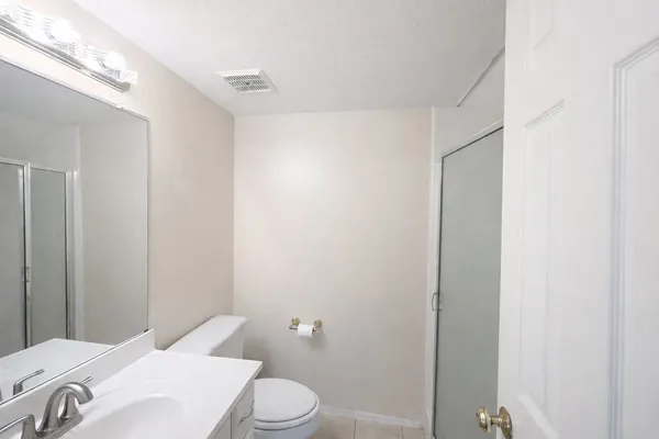 a white toilet sitting next to a bathroom sink