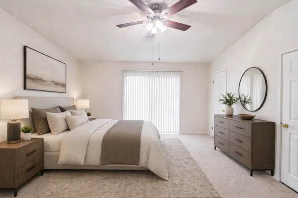 a bedroom with bed and a chandelier