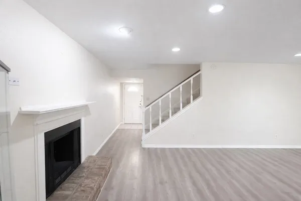 a view of entryway and hall with wooden floor