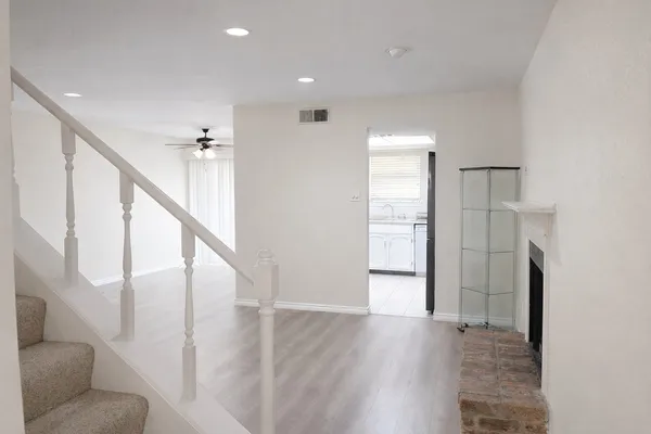 a view of entryway and hall with wooden floor
