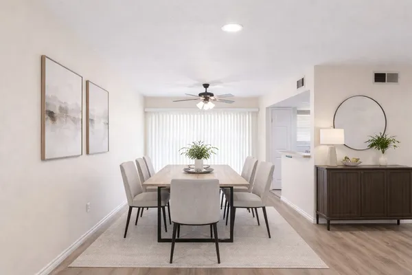 a view of a dining room with furniture and wooden floor