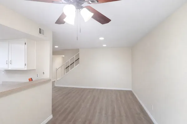 a view of an empty room and wooden floor