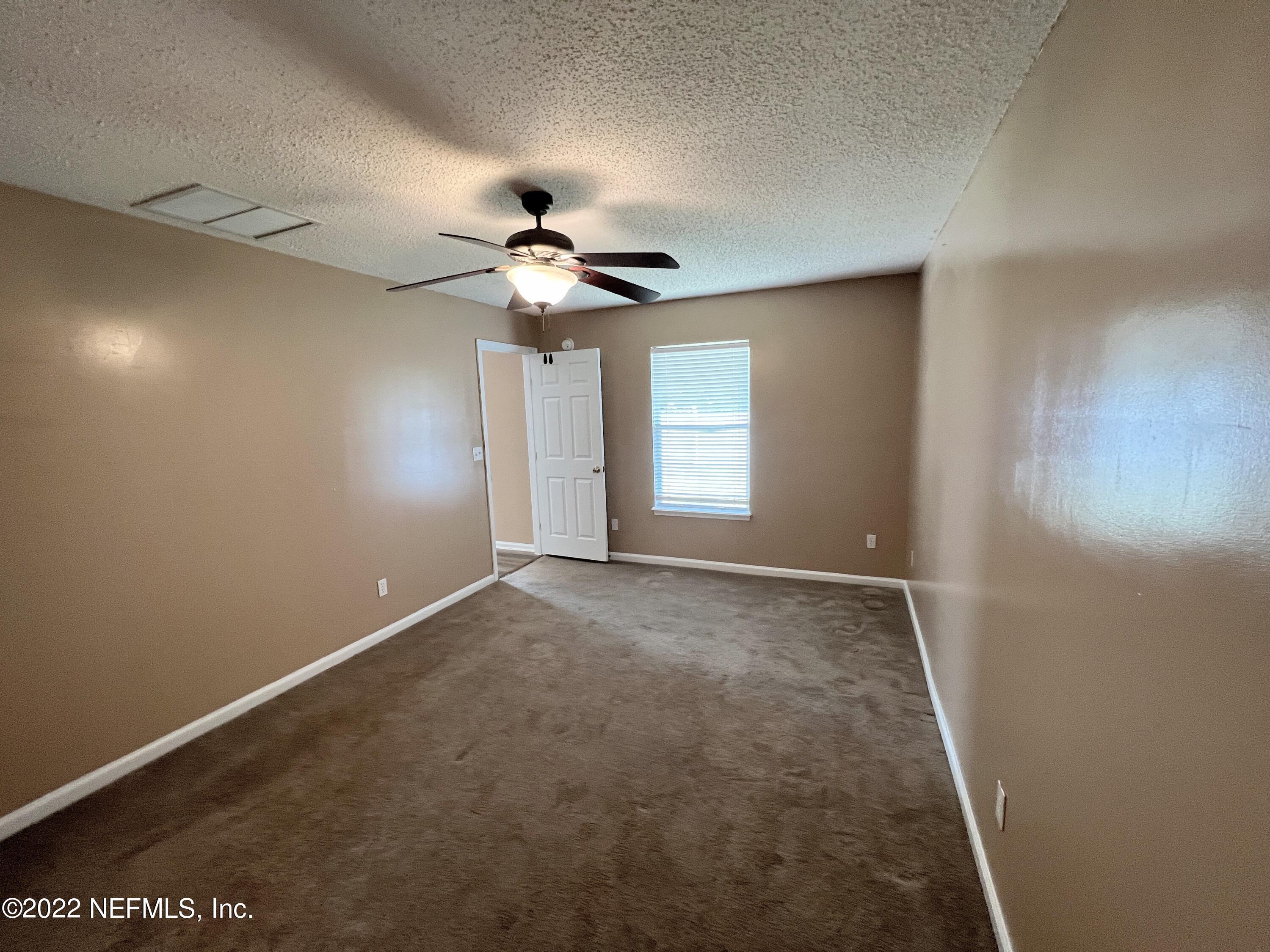 3742 Star Leaf Road West Jacksonville, FL 32210 - Photo 19 of 39 an empty room with windows and fan