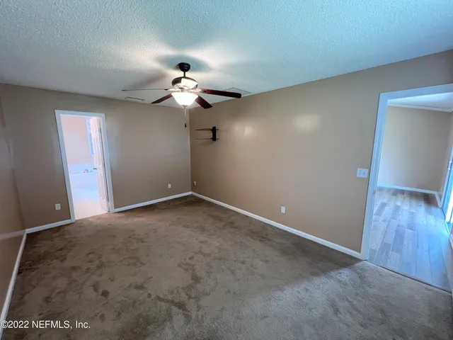 a view of a chandelier fan in an empty room