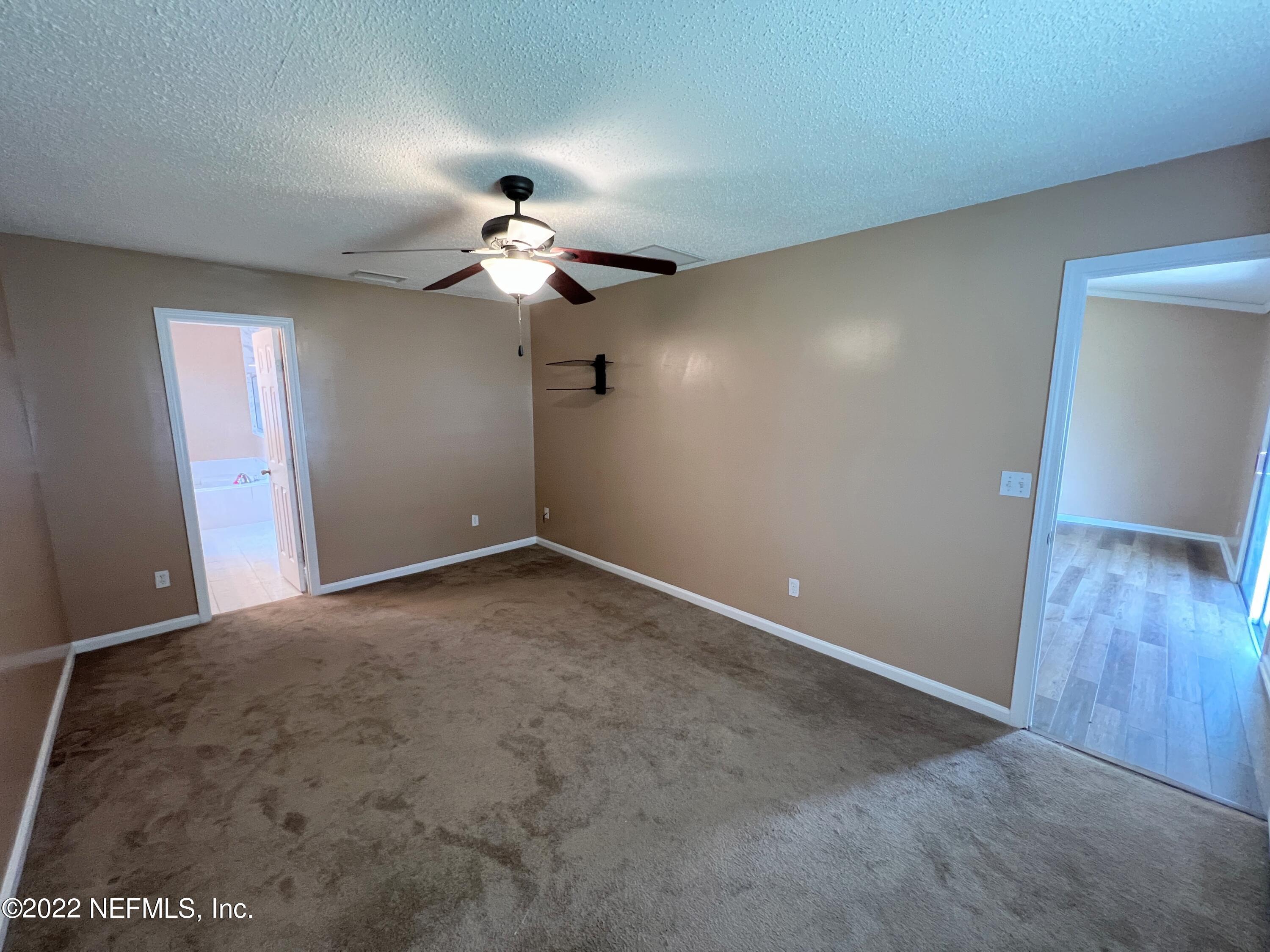 3742 Star Leaf Road West Jacksonville, FL 32210 - Photo 20 of 39 a view of a chandelier fan in an empty room