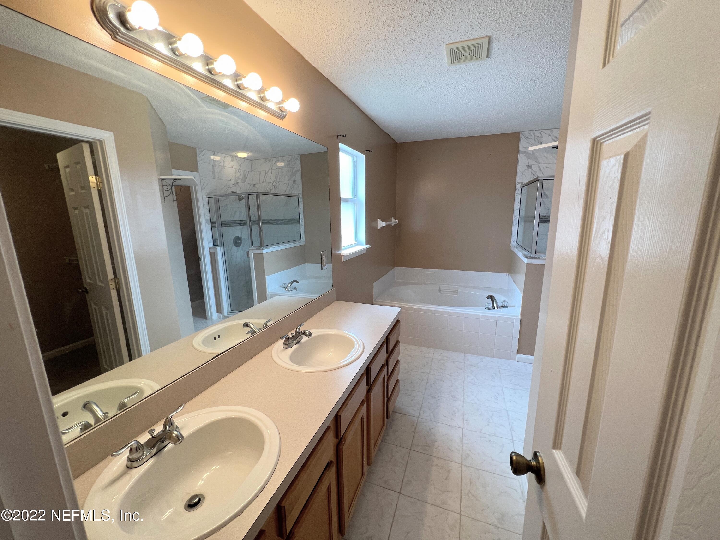 3742 Star Leaf Road West Jacksonville, FL 32210 - Photo 21 of 39 a en suite bathroom with a sink a mirror and a shower