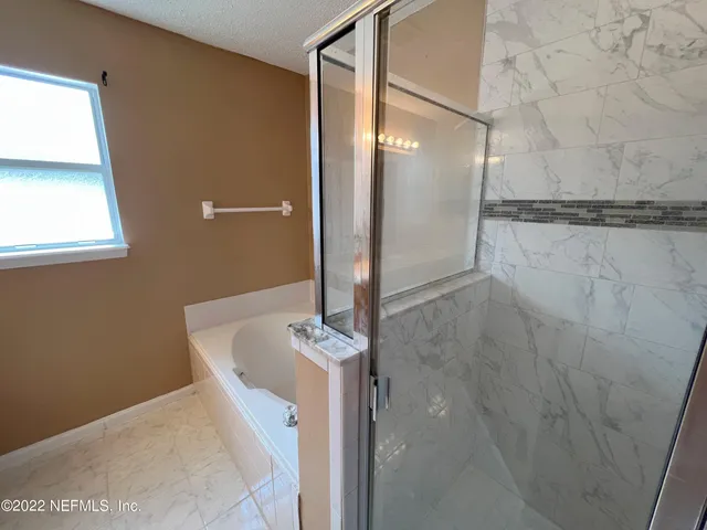 a bathroom with a bathtub and shower
