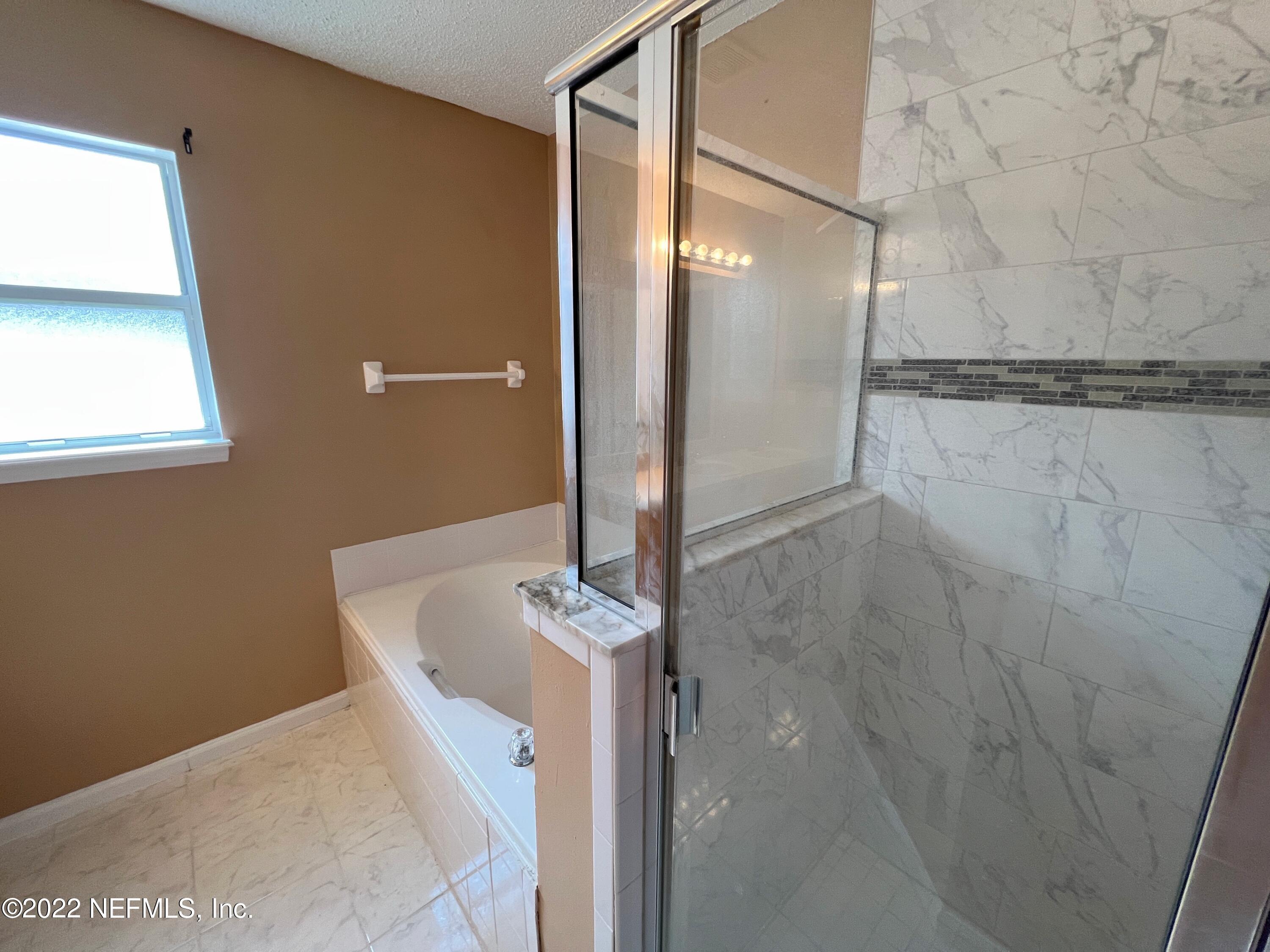 3742 Star Leaf Road West Jacksonville, FL 32210 - Photo 25 of 39 a bathroom with a bathtub and shower